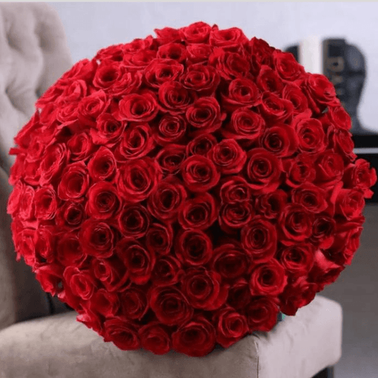 Bouquet of red roses on a gray surface with a blurred background