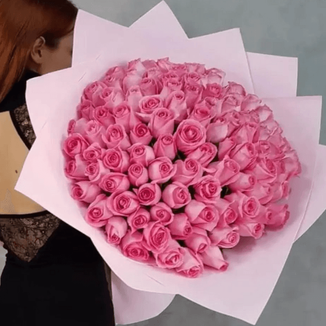 Fifty pink roses in a hand-tied luxury bouquet, arranged by Goshen Flower. Elegant rose bouquet for delivery in Dubai.