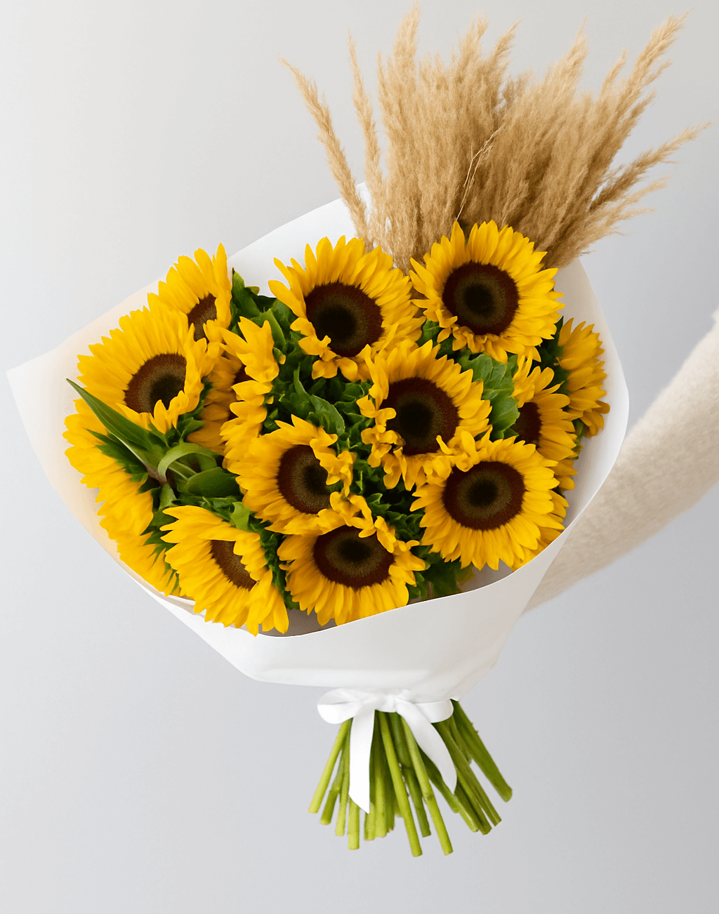 Golden Hour Blooms sunflower bouquet with pampas grass wrapped in white paper, available for same-day flower delivery in Dubai