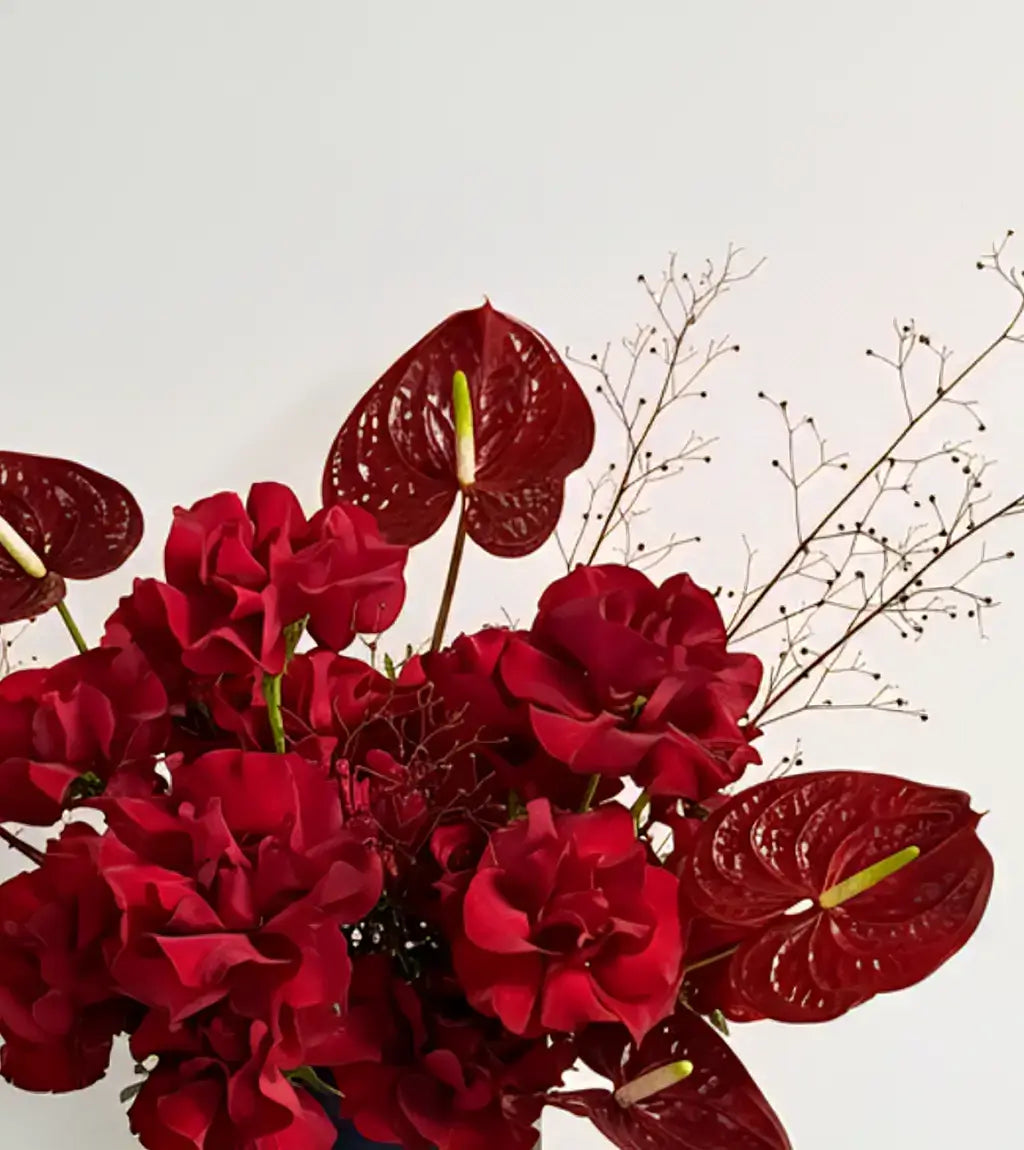 Square view of Moscow Bouquet with red roses and striped anthuriums in Dubai