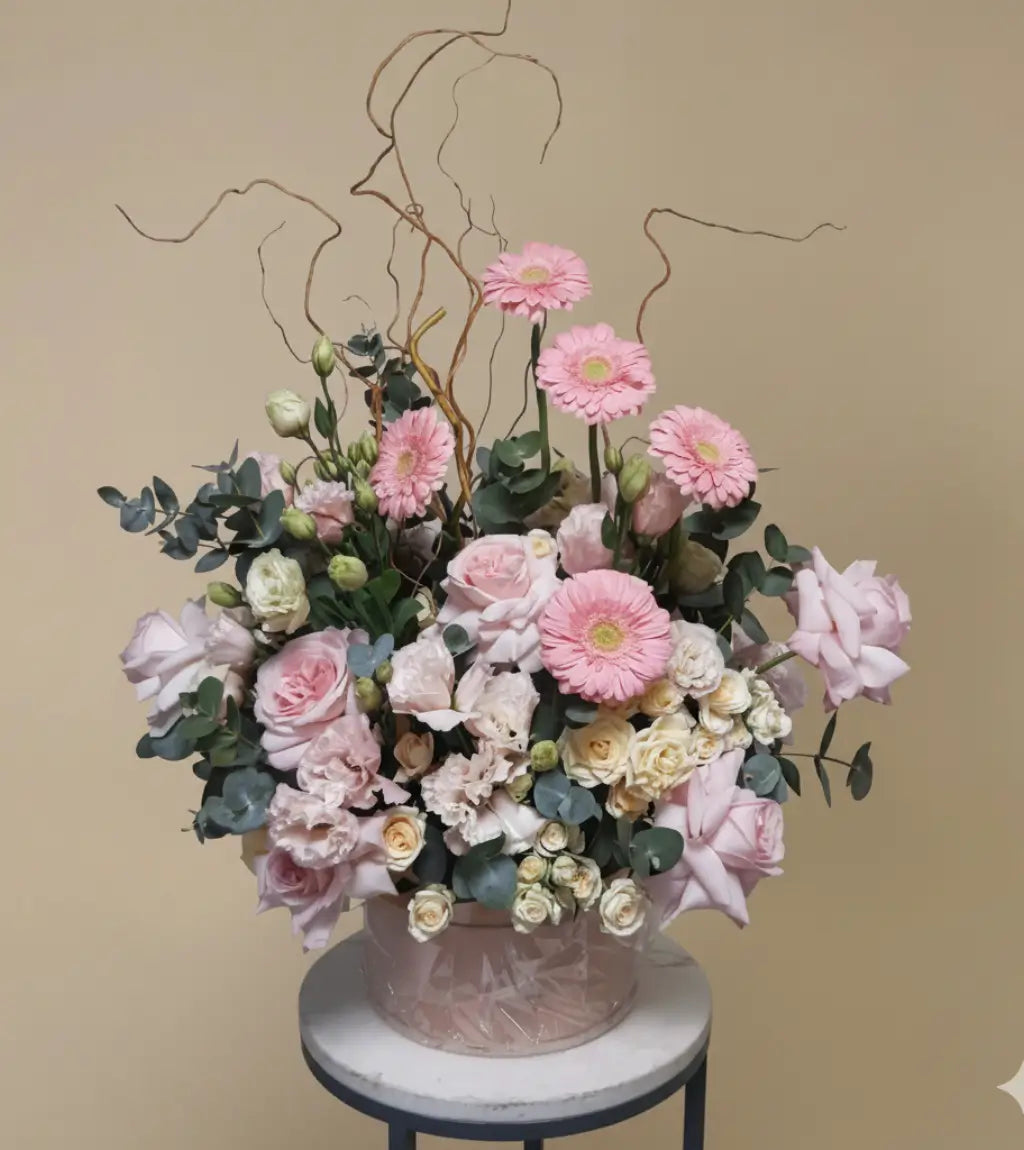 Elegant peach and blush flower box with roses and orchids in a neutral hatbox, handcrafted by Dubai online florist