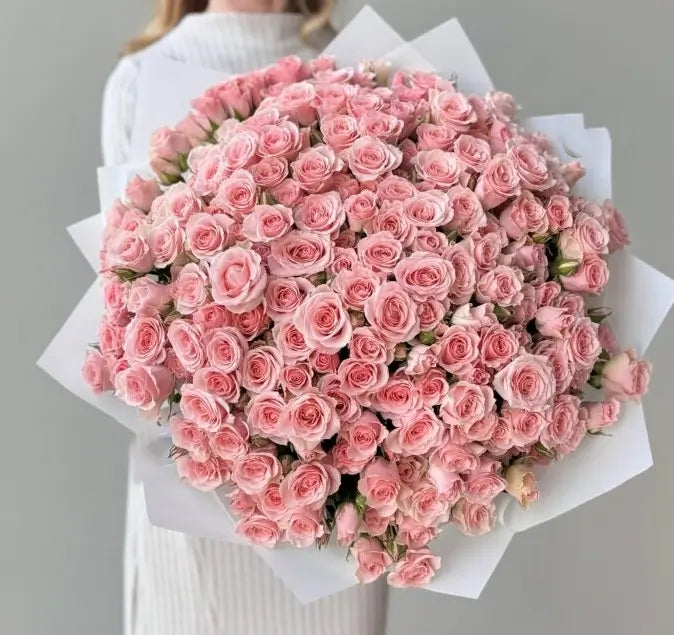 t: Pretty in Pink bouquet with 60 pink spray roses wrapped in matte film and tied with ribbons – flower delivery Dubai