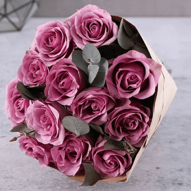 A bouquet of 12 purple roses, hand-tied by Goshen Flower in Dubai. Elegant and romantic flower arrangement perfect for special occasions.