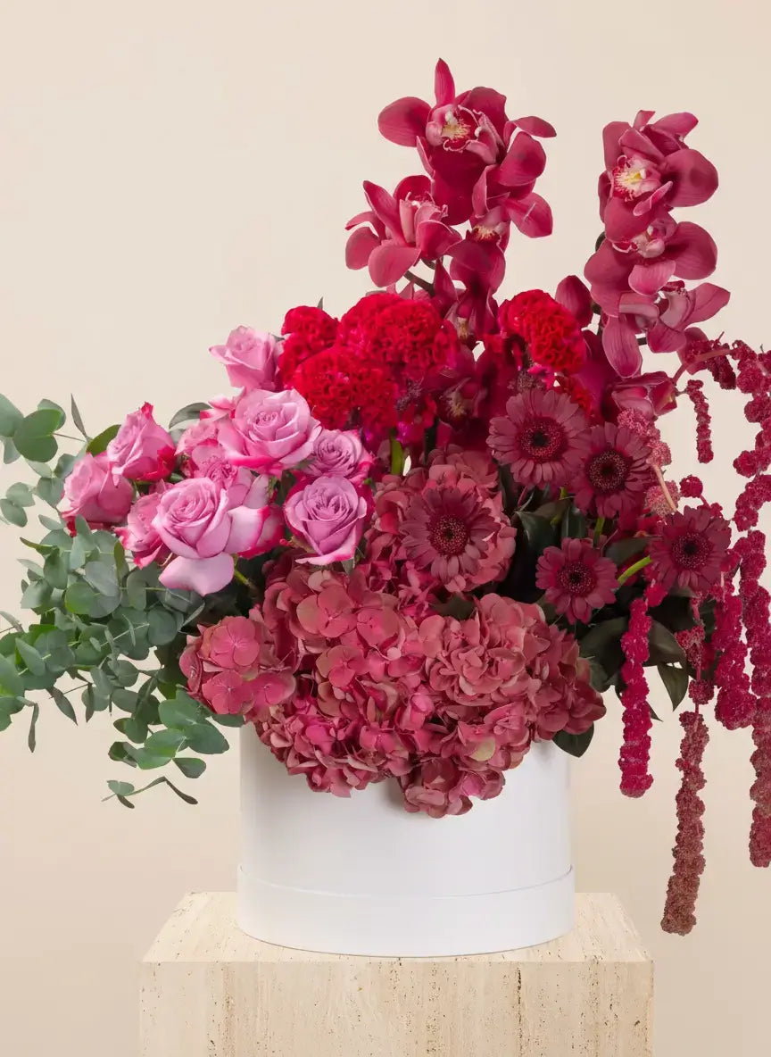 Bouquet of pink and red flowers in a white vase for dubai delivery