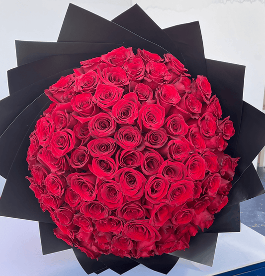 100 red roses bouquet wrapped for romantic gift – flower delivery Dubai
