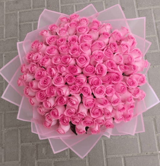 Stunning bouquet of 100 pink roses, hand-tied by Goshen Flower for luxury delivery in Dubai. Perfect for proposals and grand gestures.
