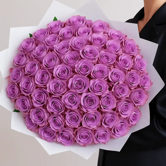 Bouquet of purple roses held by a person wearing a black outfit in dubai
