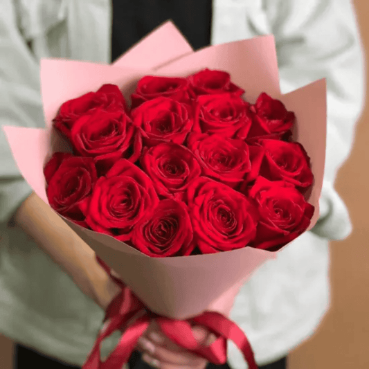 Fifteen red roses arranged into a hand-tied romantic bouquet by Goshen Flower in Dubai. Classic floral gift for love and passion.