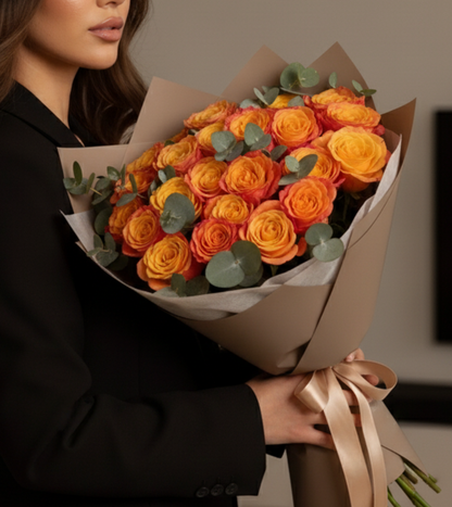 Two dozen hand-selected tangerine orange roses — boldly arranged and luxury-packaged for same-day delivery across Dubai.