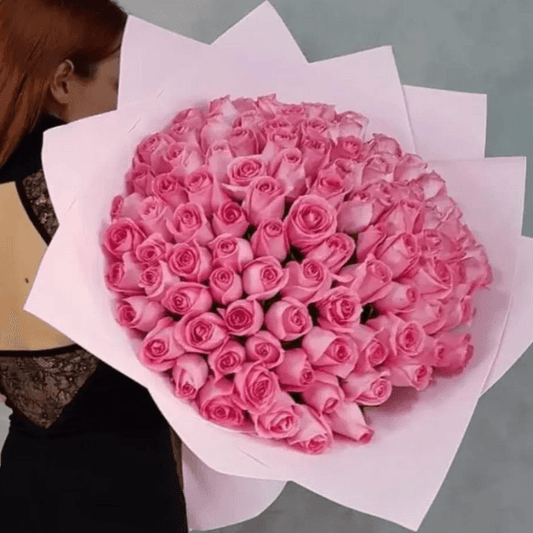 Fifty pink roses in a hand-tied luxury bouquet, arranged by Goshen Flower. Elegant rose bouquet for delivery in Dubai.