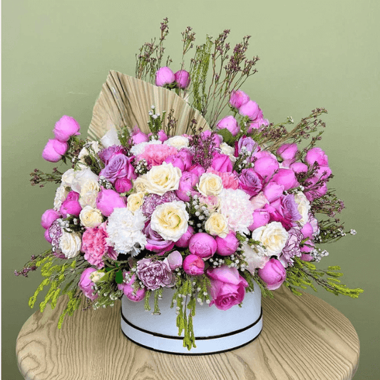 Luxury pink and lavender flower hatbox with roses, carnations, and white chrysanthemums for same-day delivery in Dubai UAE