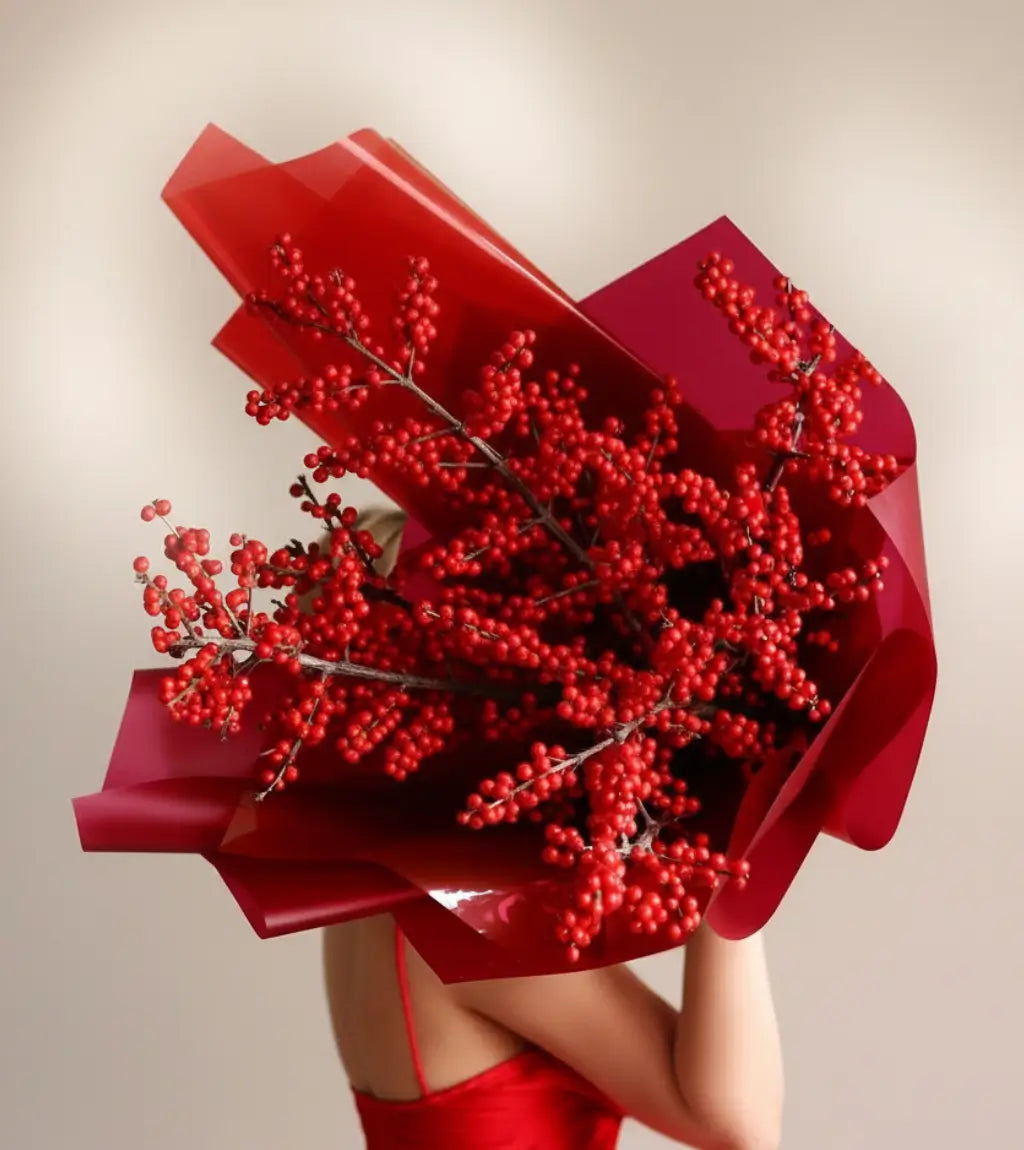 Berry Blaze monochromatic red ilex berry arrangement with abundant clustered stems in sleek red paper wrapping for modern Dubai homes