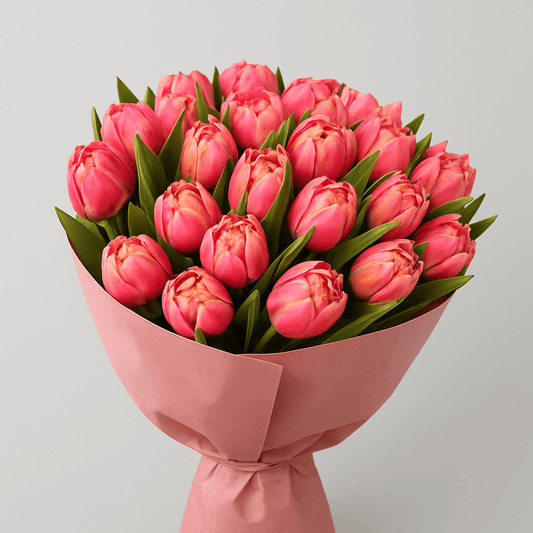 Bouquet of Dancing Salsa pink tulips wrapped in blush paper, perfect for gifts and special occasions.