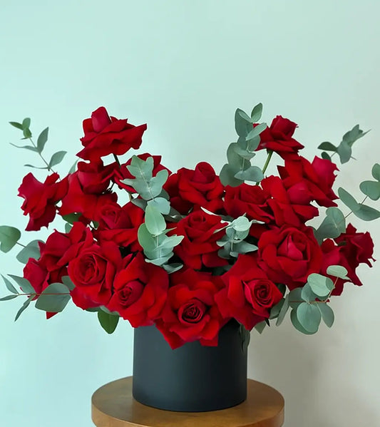Luxury red rose bouquet with eucalyptus in black hatbox – Dubai flower delivery