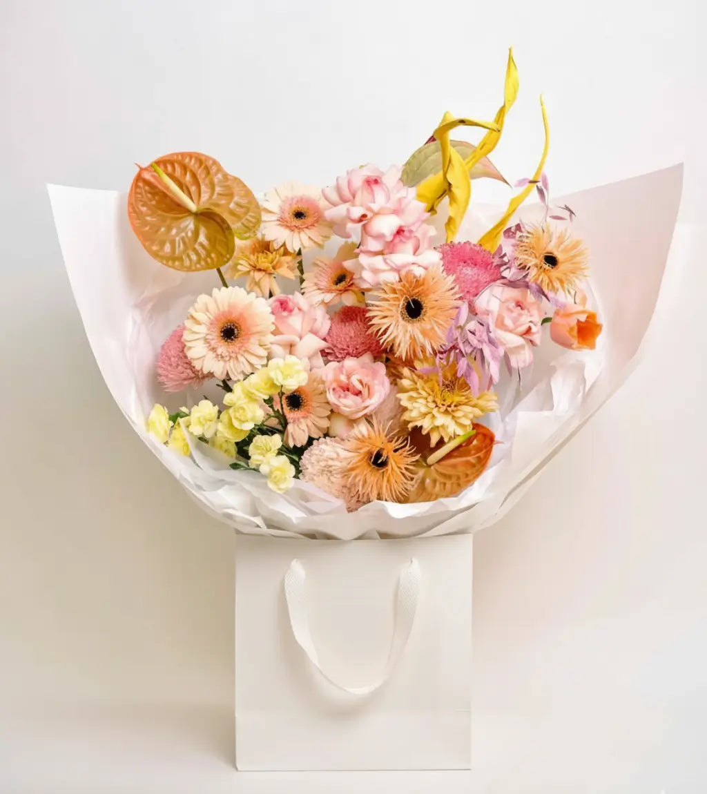 Golden Hour Glow bouquet with peach dahlias, creamy yellow calla lilies, and anthuriums — flower delivery Dubai