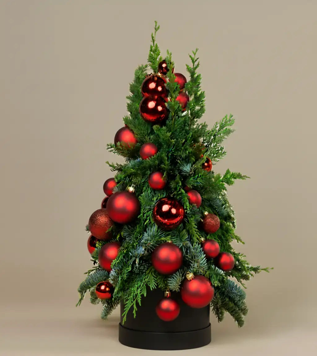 Mini Majesty Christmas Tree pre-decorated tabletop tree with lush evergreens, glossy red and burgundy ornaments in sleek black base for Dubai delivery