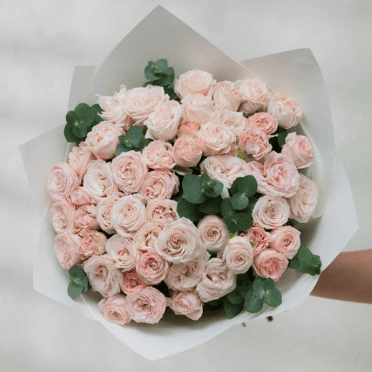 Petite bouquet of pink baby roses, handcrafted by Goshen Flower in Dubai. Ideal for new baby gifts and sweet surprises.